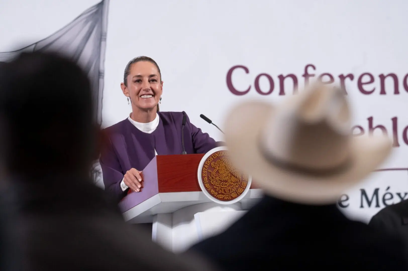 Speaker at podium during a conference event.