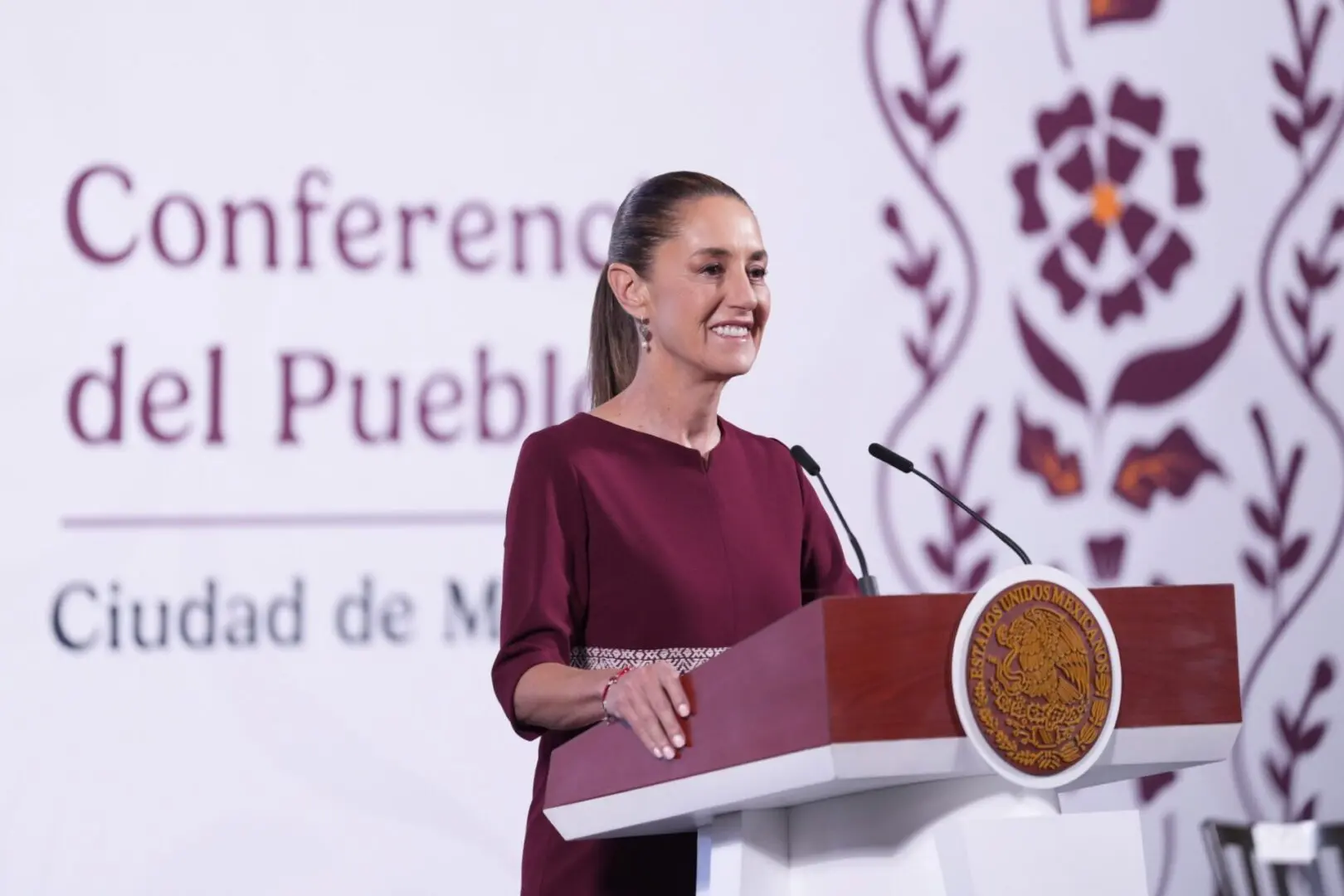 Woman speaking at a podium during conference.