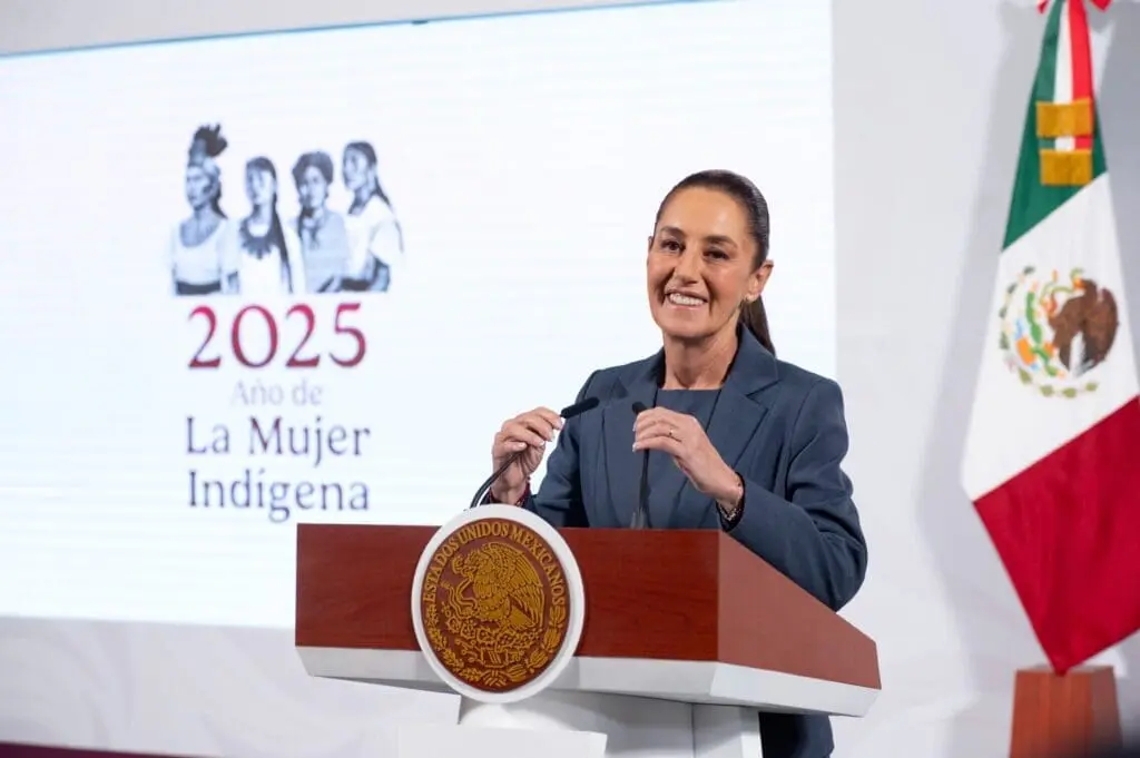 Woman speaking at podium, 2025 Indigenous Women event.