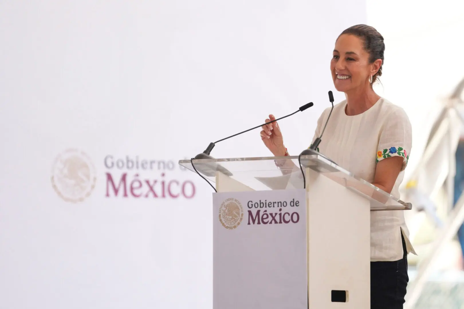 Woman speaking at Mexico government podium