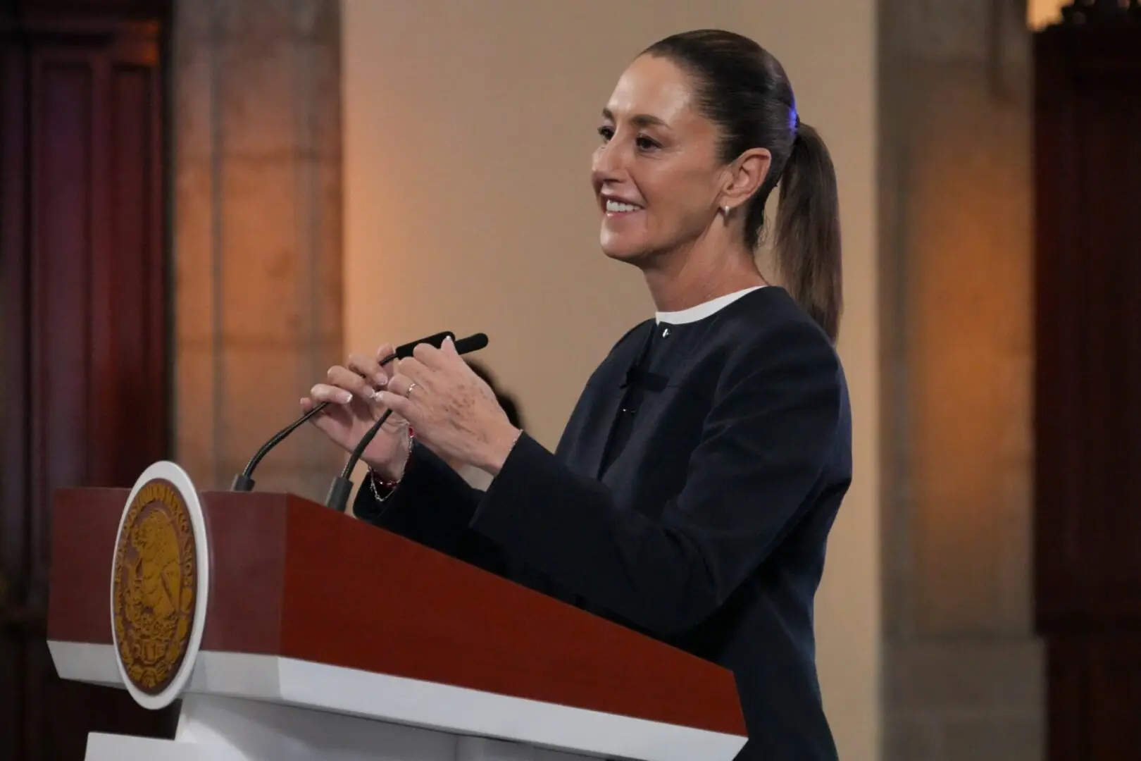 Woman speaking at a podium during event.