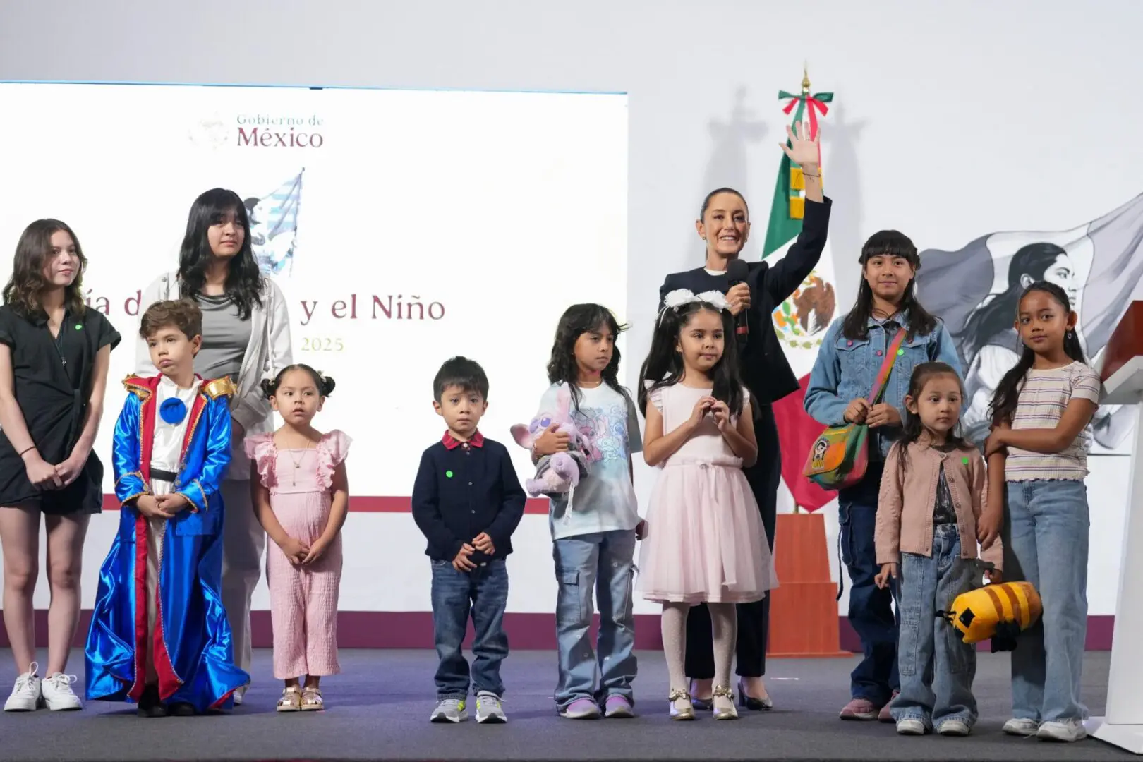 Group of children and adults on stage.