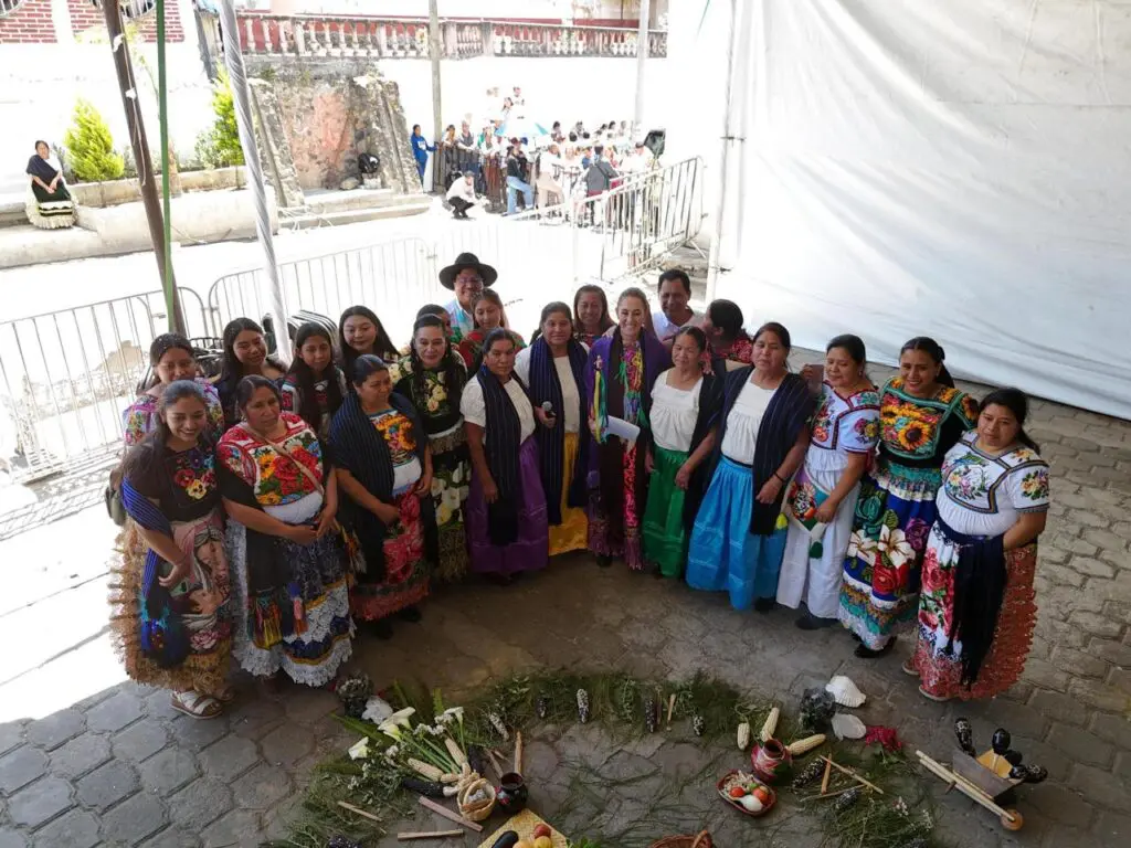 Women in traditional attire around ceremonial circle.