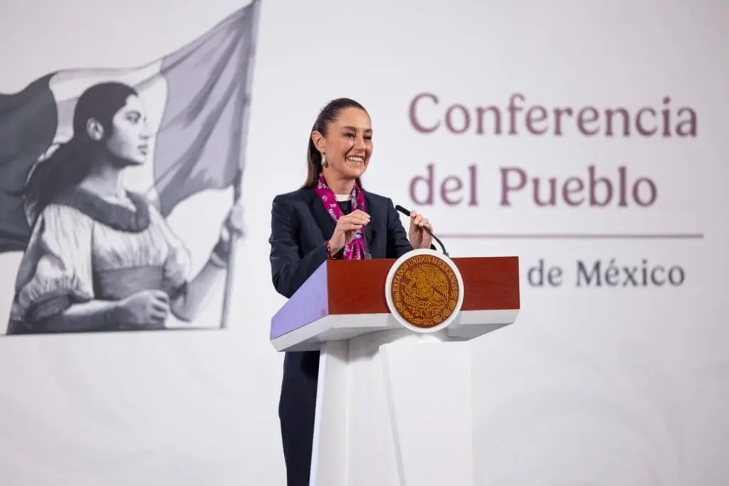 A woman speaking at a podium during a conference.