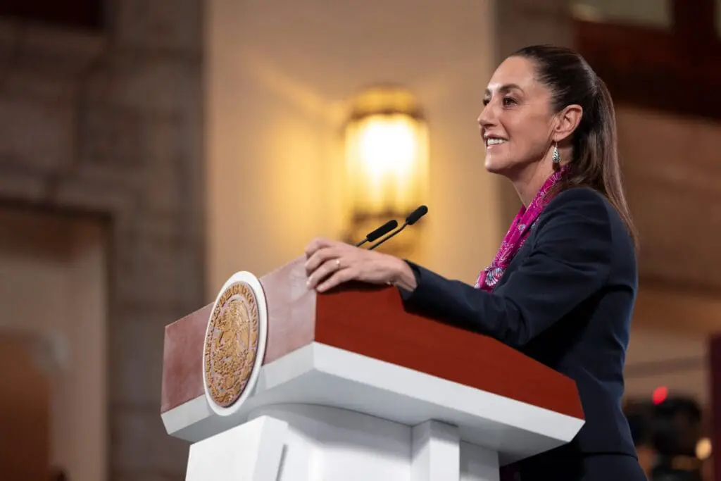 A woman speaking at a podium with a microphone.