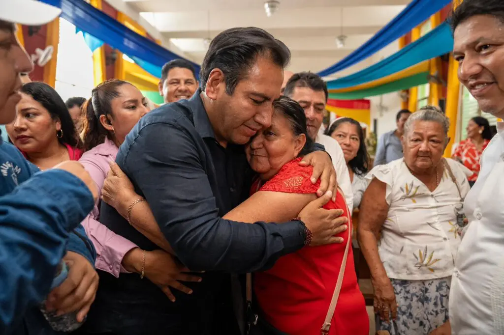 People hugging at a public gathering event.