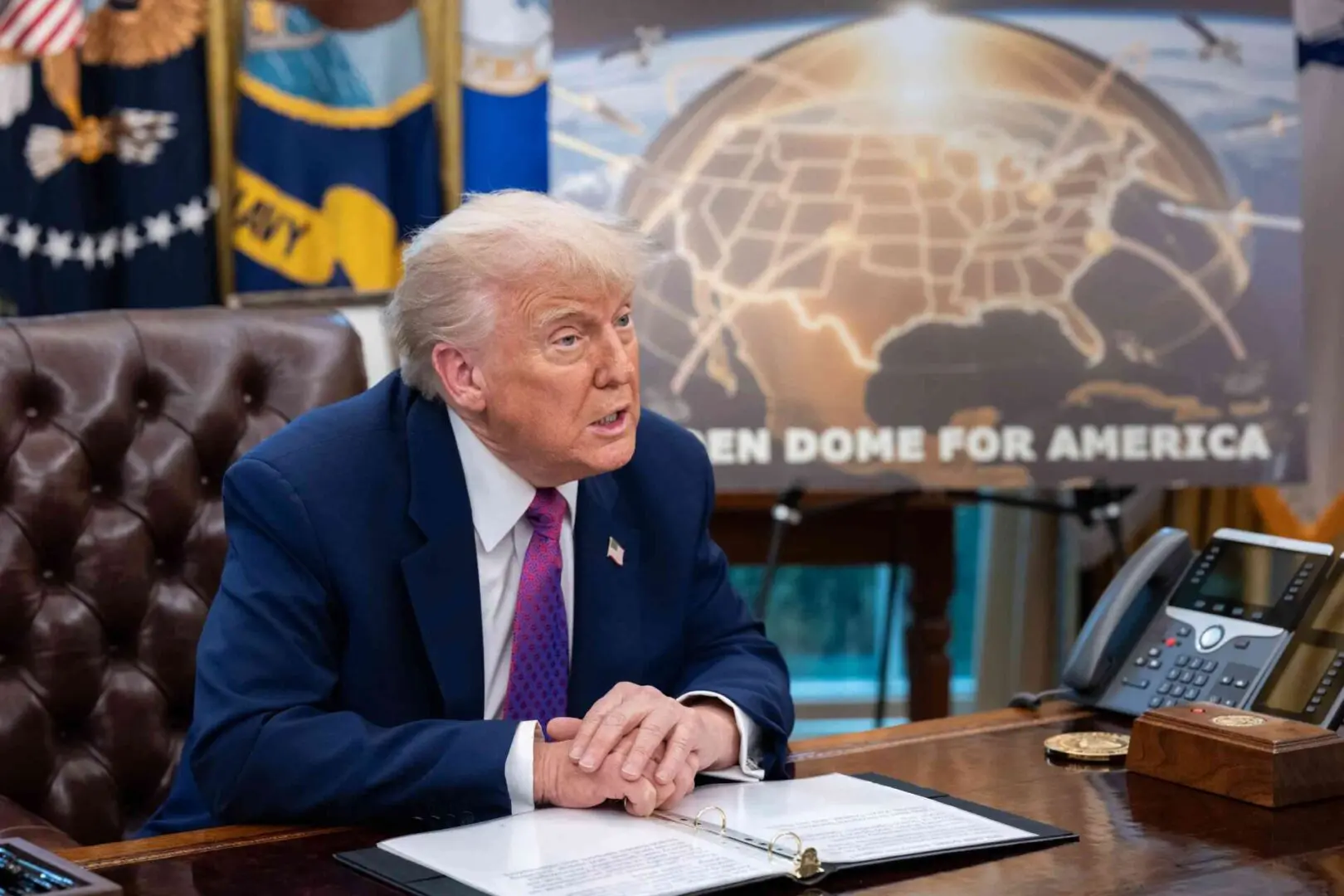 Man sitting at desk with map background.
