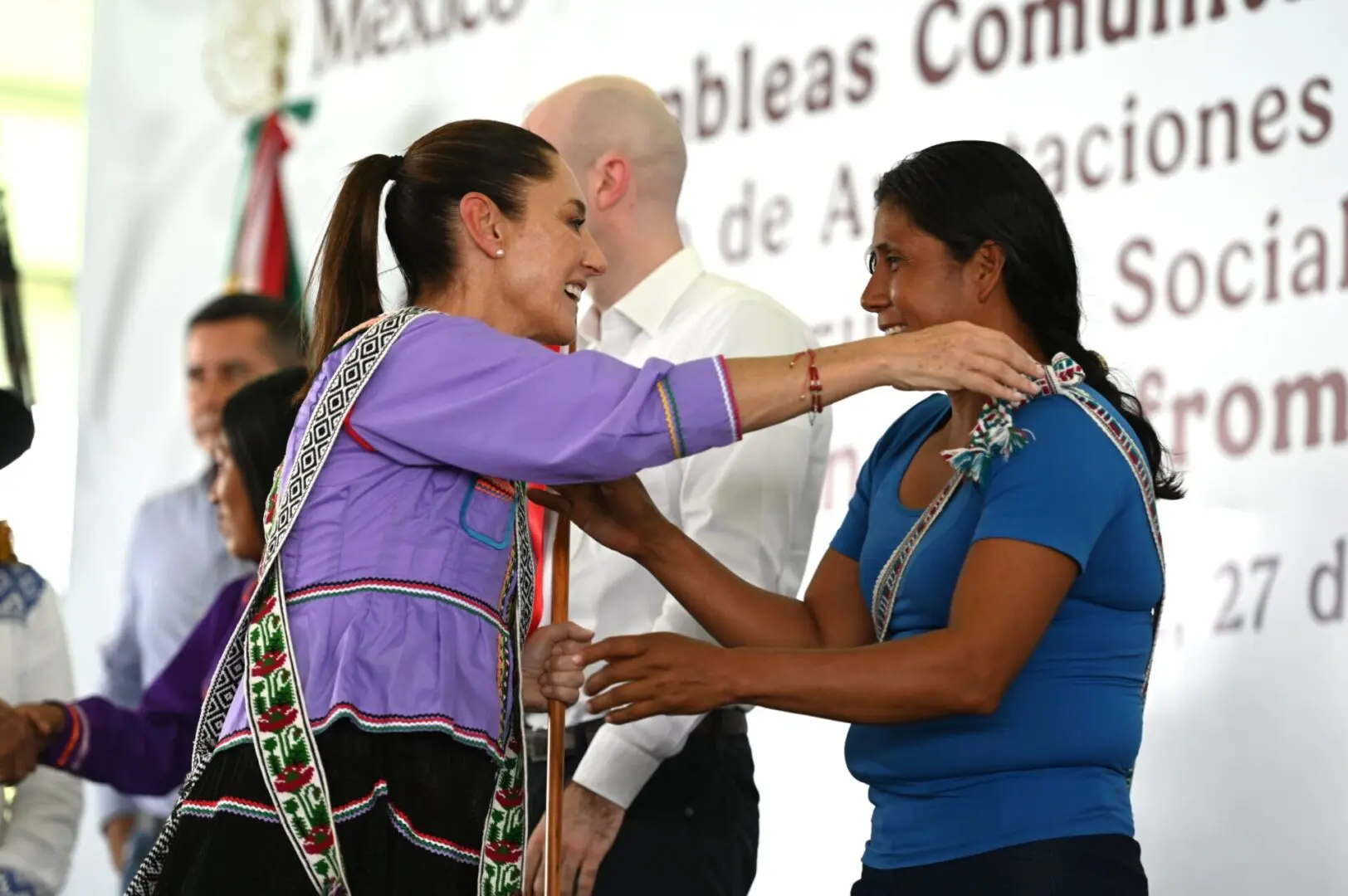 Two women exchanging a friendly gesture.
