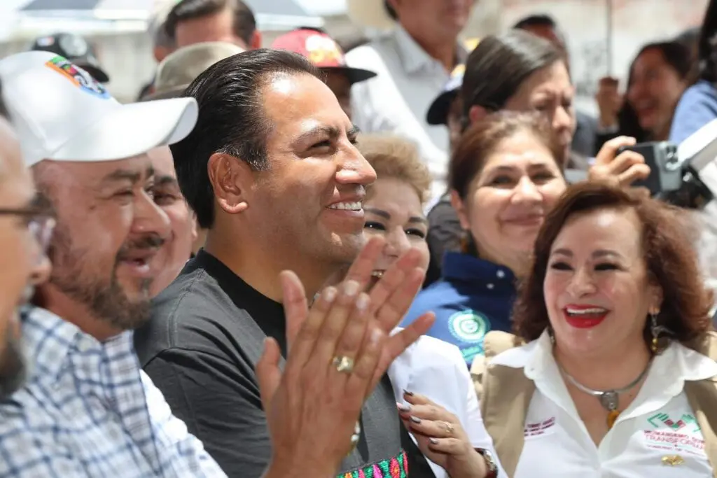 group of smiling people applauding at event