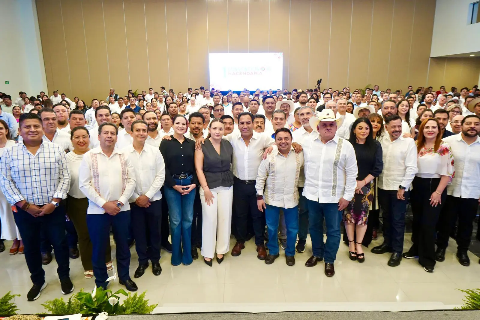 Large group of people posing indoors.