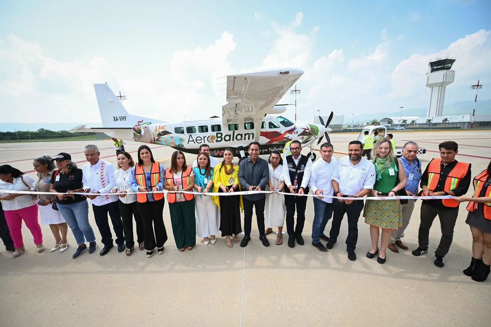 People at airplane ribbon-cutting ceremony.