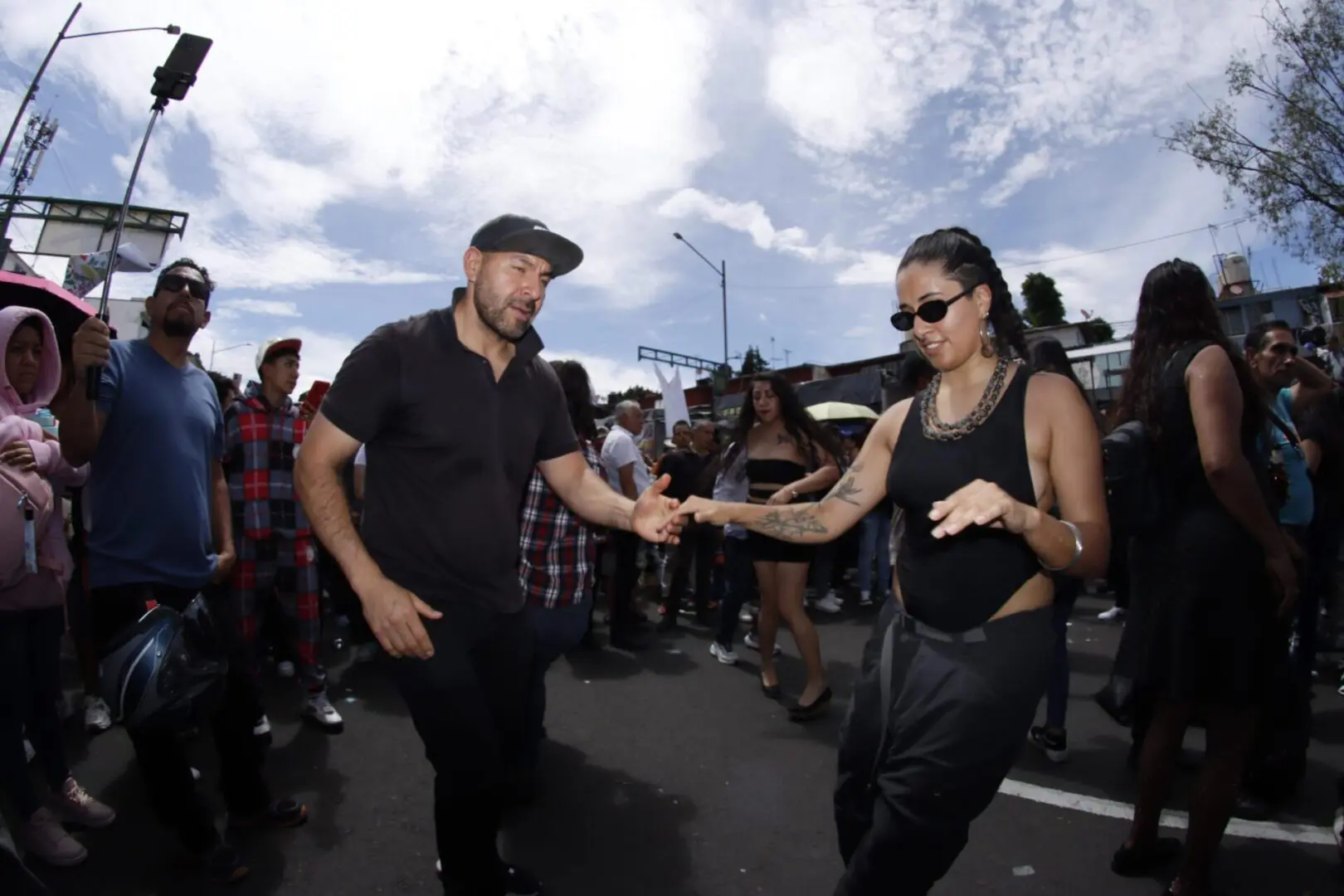 People dancing outdoors at a street event.