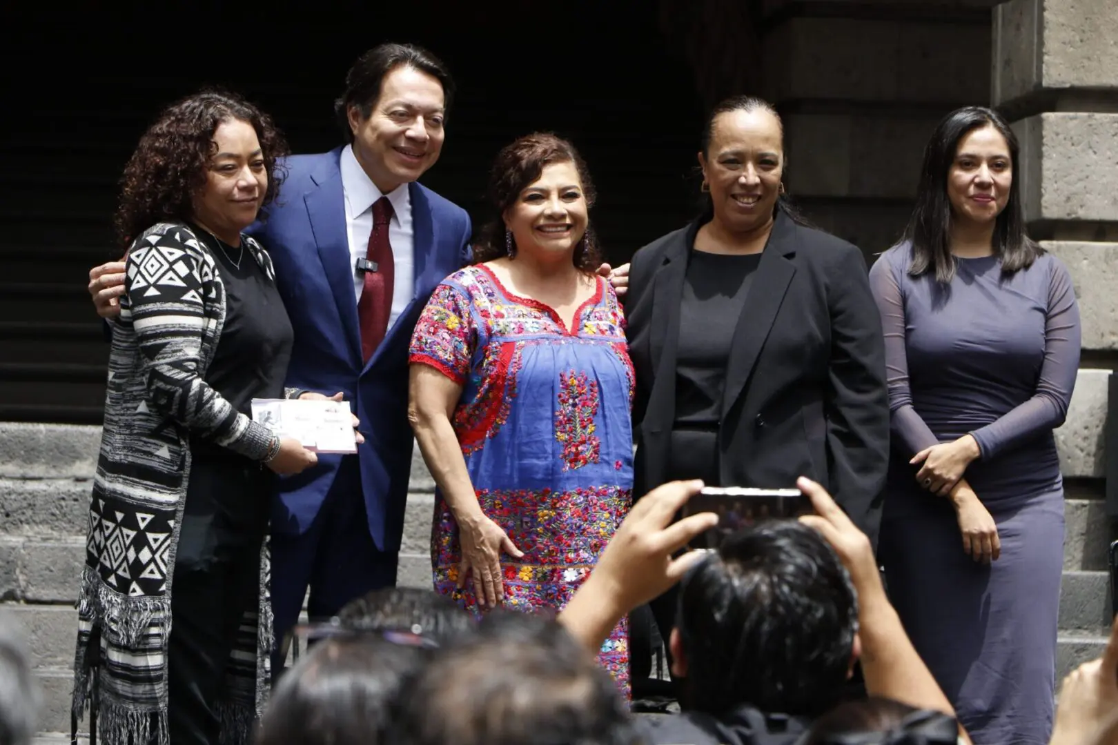 Group of five people posing for photo.
