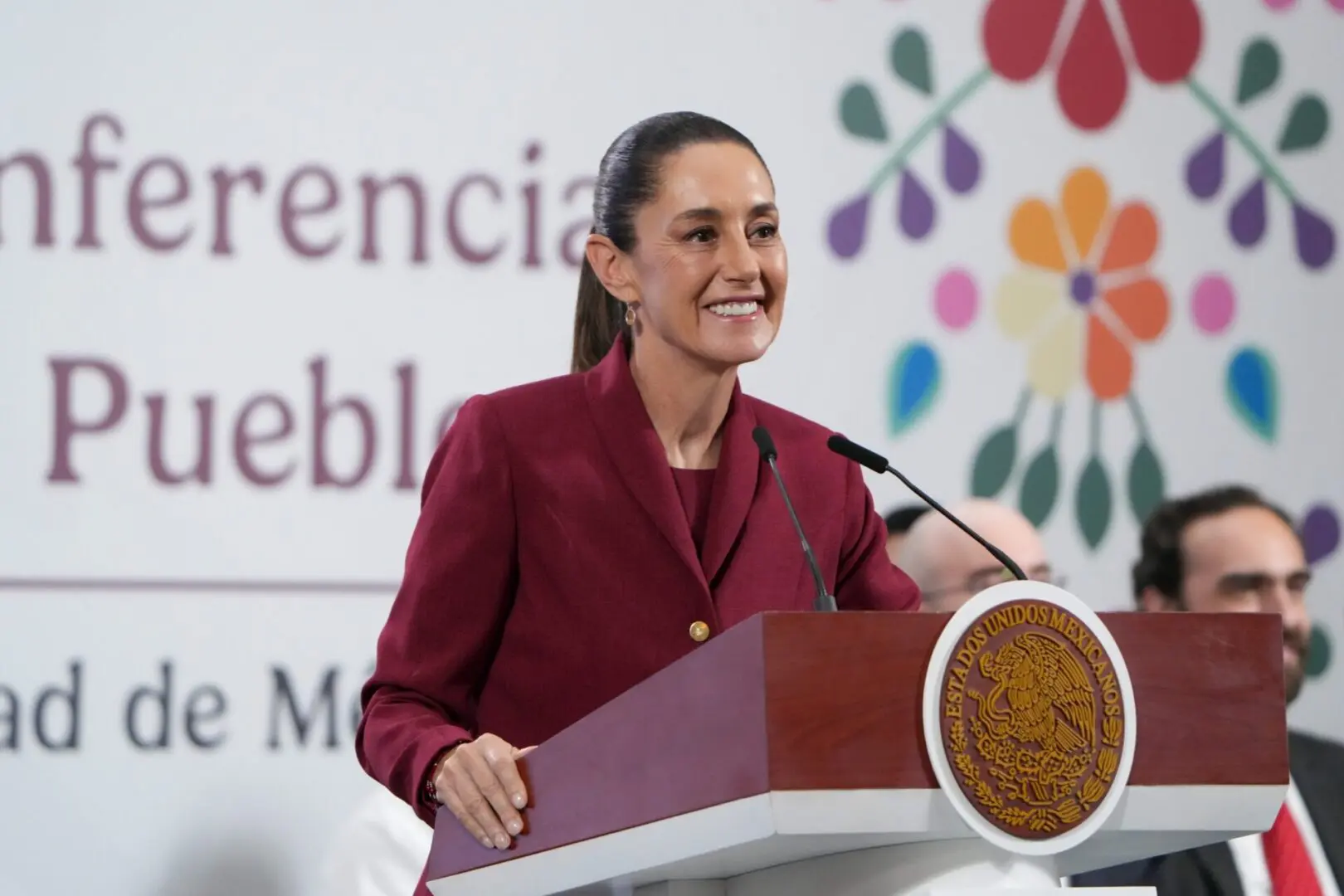 Woman speaking at press conference podium