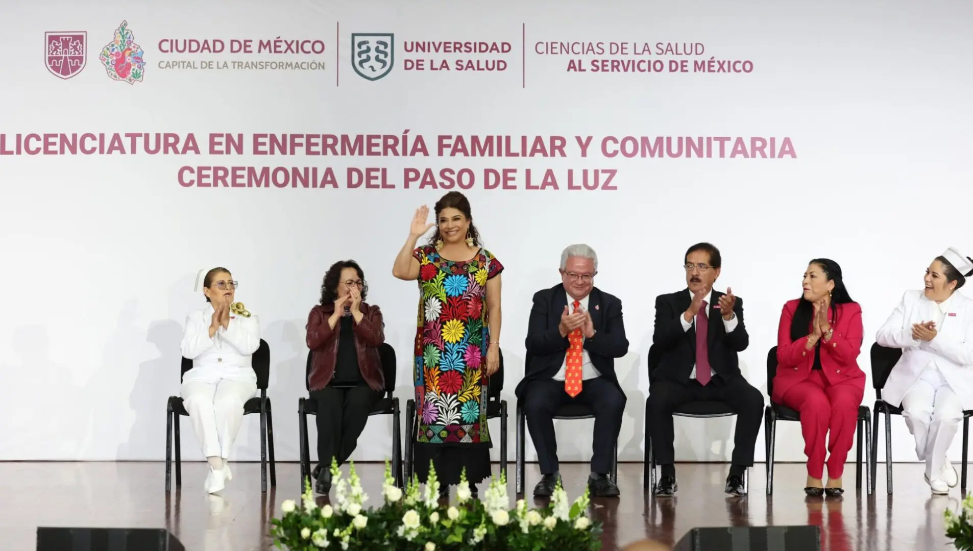Graduation ceremony with people on stage.