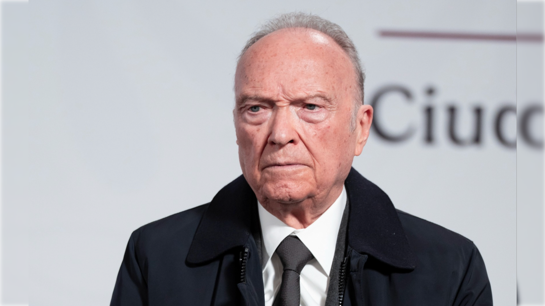 serious older man wearing suit and tie