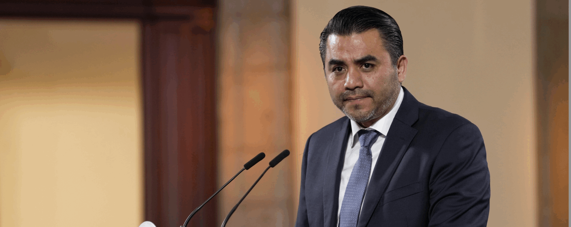 Man in suit speaking at podium