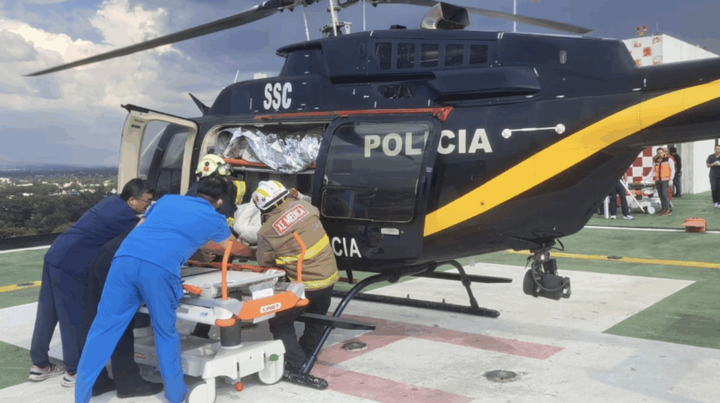 Helicopter crew assisting patient on stretcher.