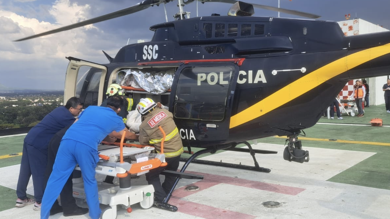 Helicopter crew assisting patient on stretcher.