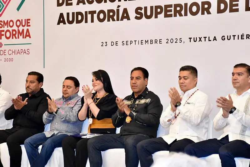 Row of officials applauding at government conference