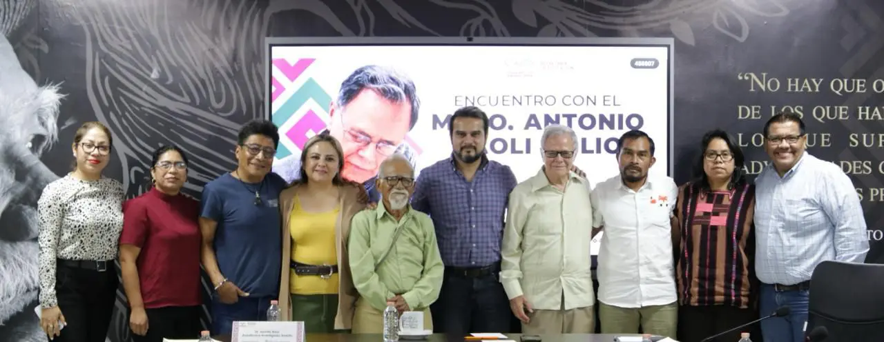 Group of people standing together, smiling.