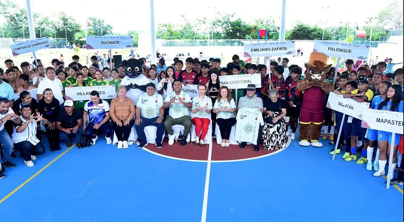 Large group on indoor sports court, smiling.