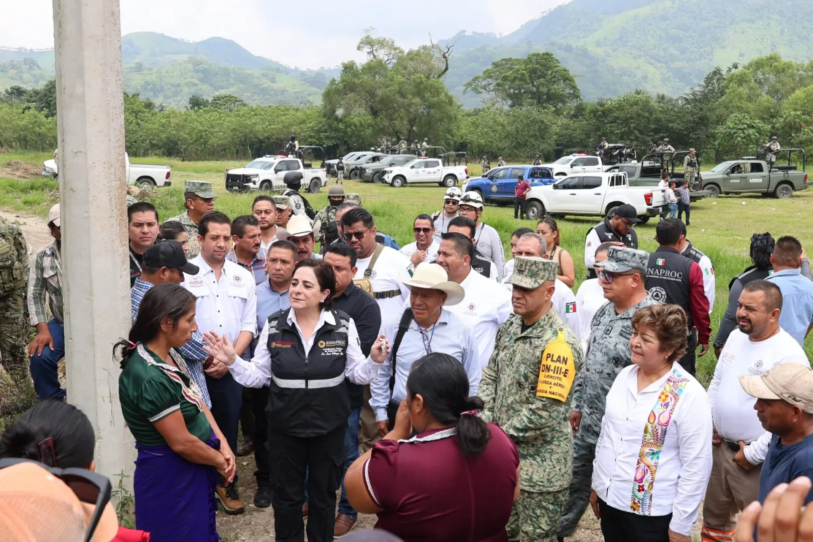 Group of people gathered outdoors, discussing.