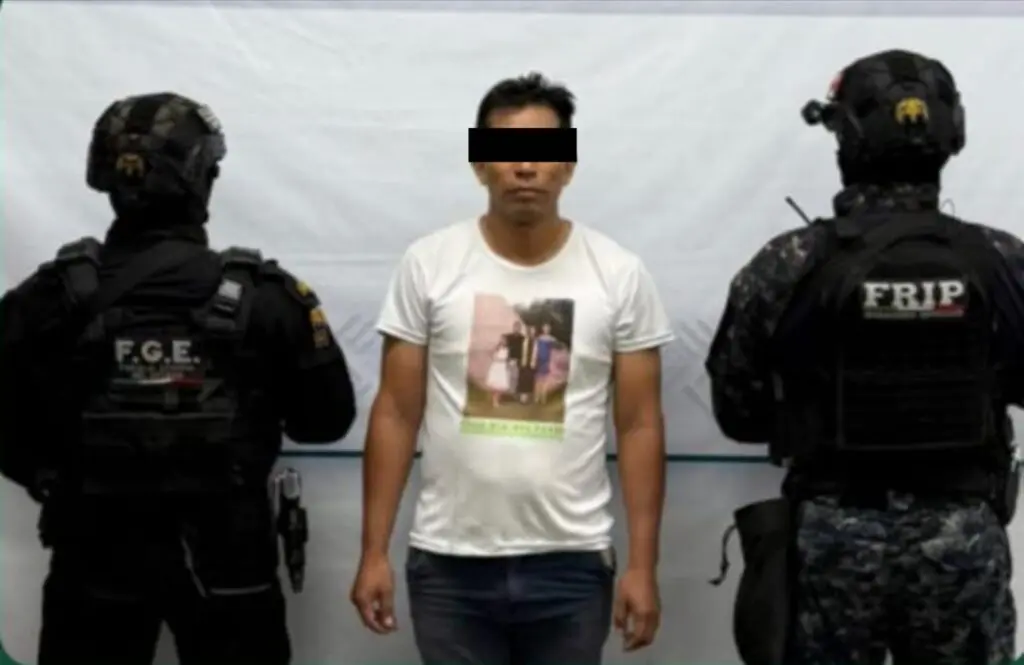 Three men, one detained by police officers.