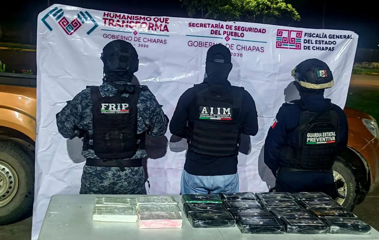 Three officers with seized packages displayed.