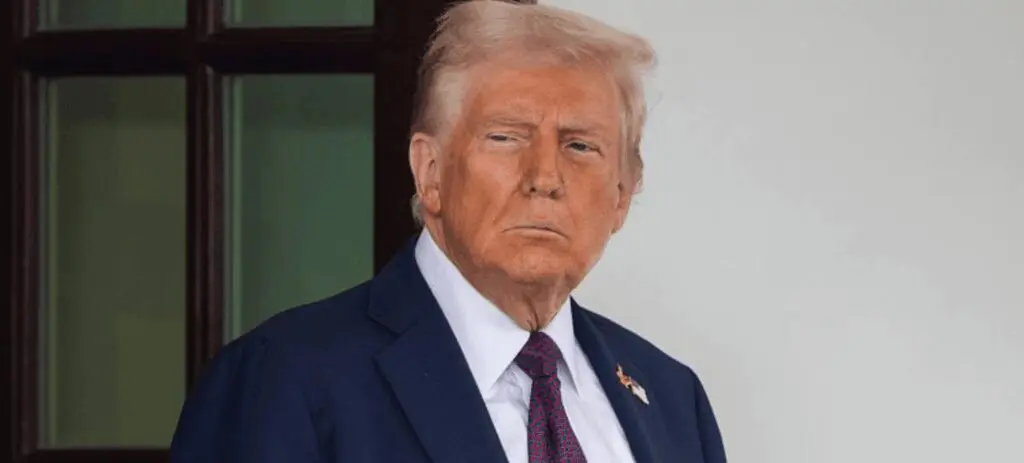 Man in navy suit with serious expression
