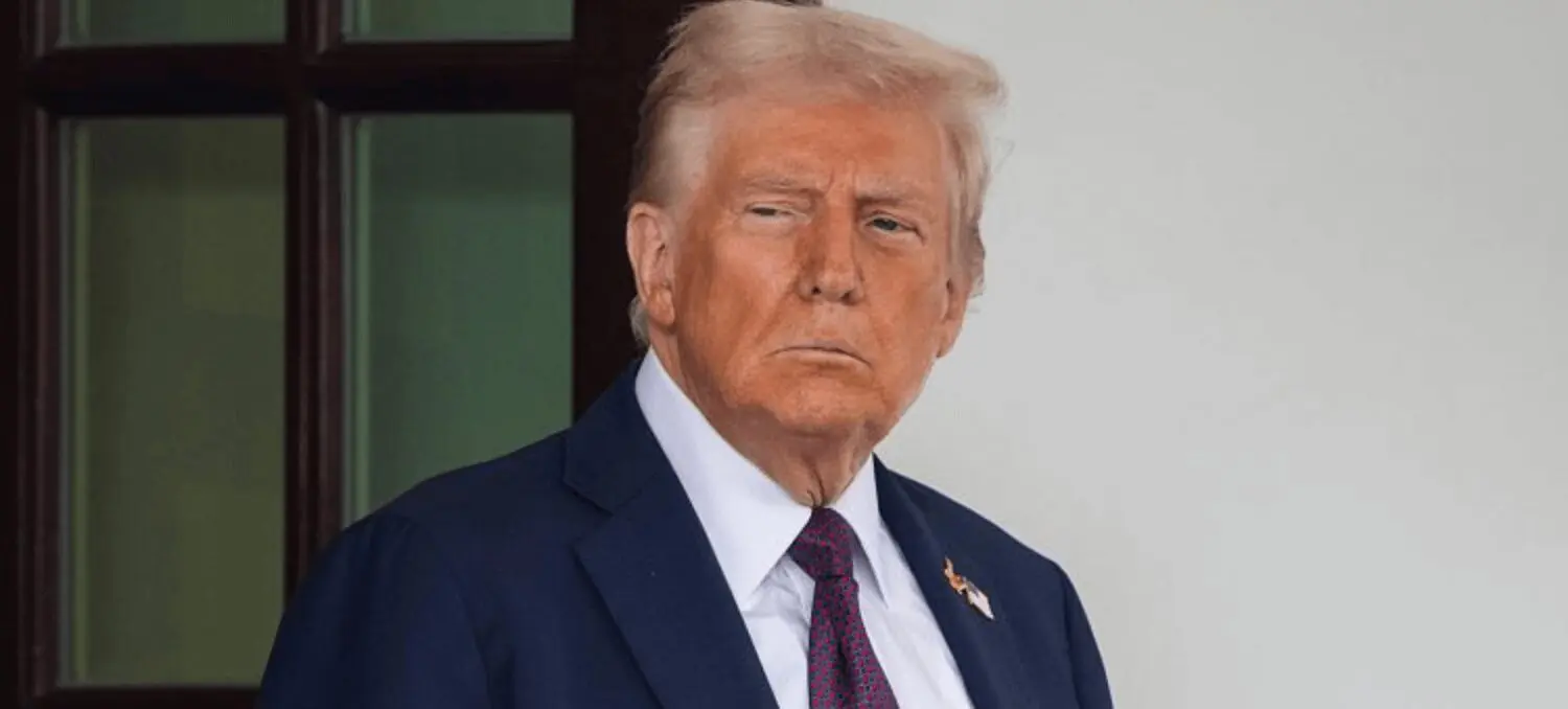 Man in navy suit with serious expression