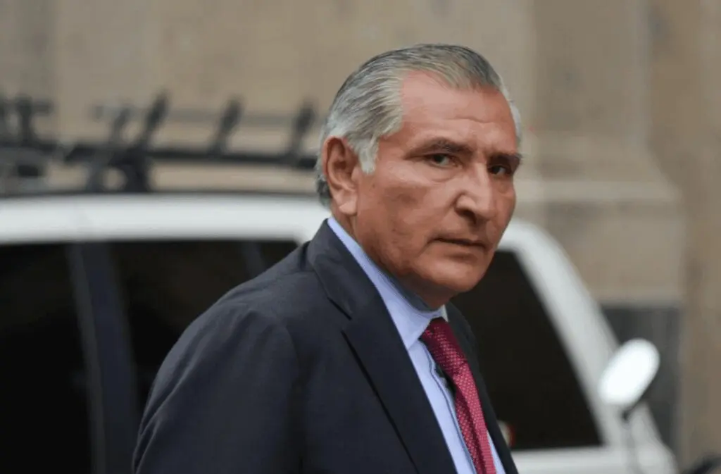Gray-haired man in suit near car