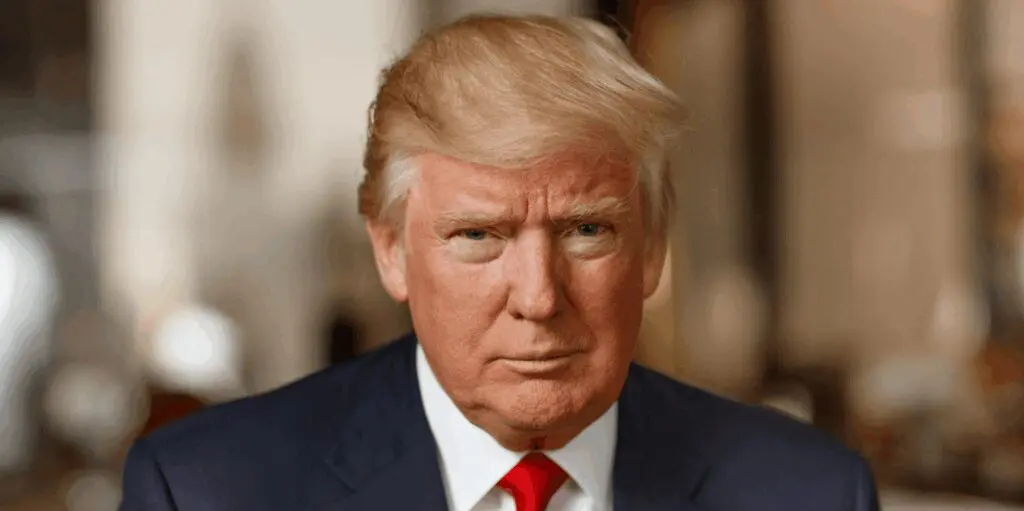 Blonde-haired man in suit and red tie