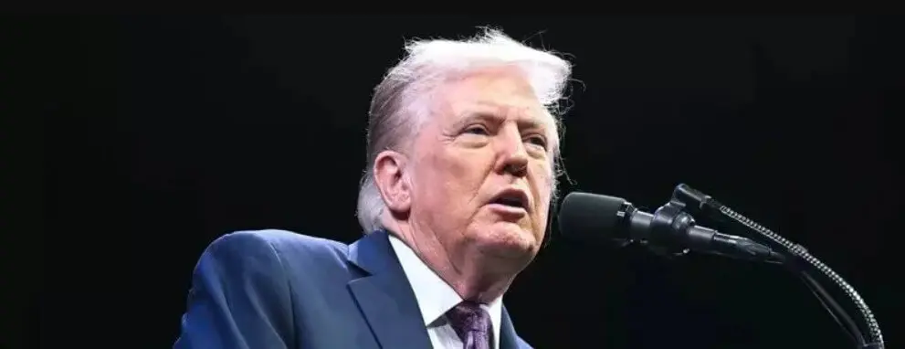 Man in suit speaking at podium