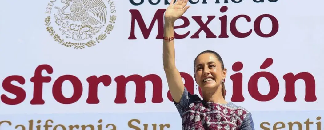 Smiling woman waving at outdoor event