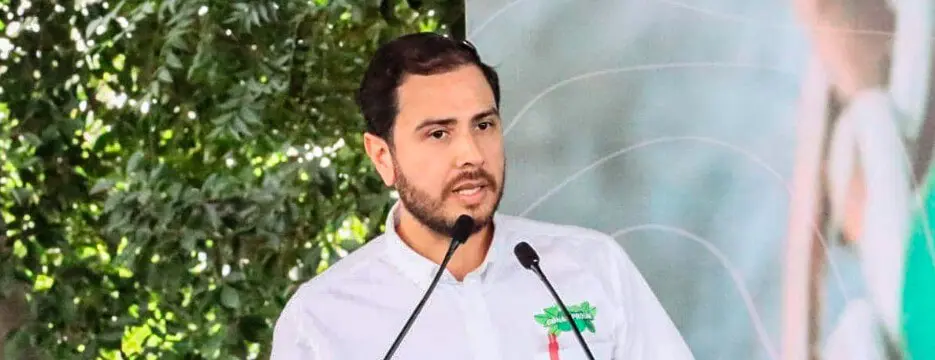 Man in white shirt speaking into microphone
