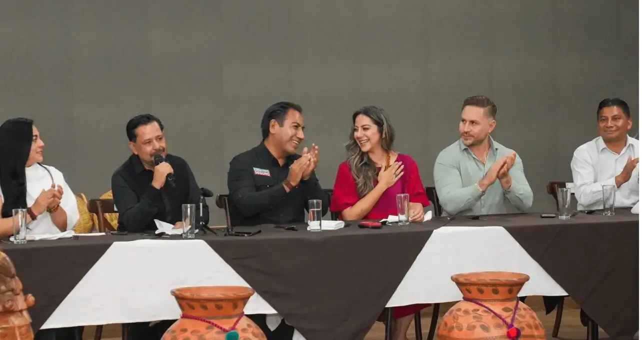 People sitting at a table, applauding.
