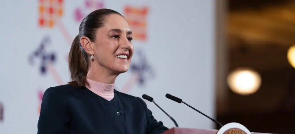 Smiling woman speaking at podium with microphones