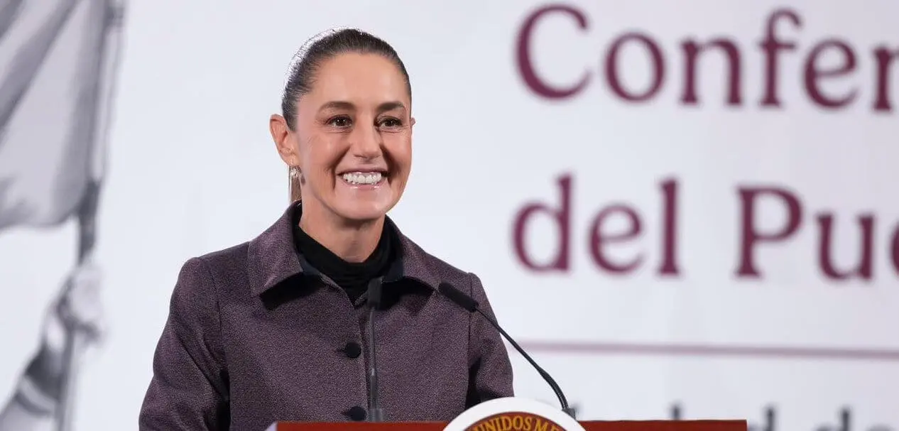 Smiling female speaker at conference podium