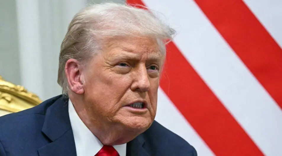 Close-up of older man in suit, flag background