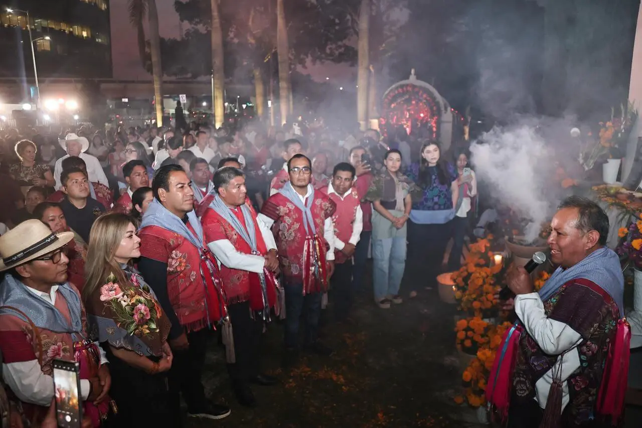 Community in red ponchos listening to speaker