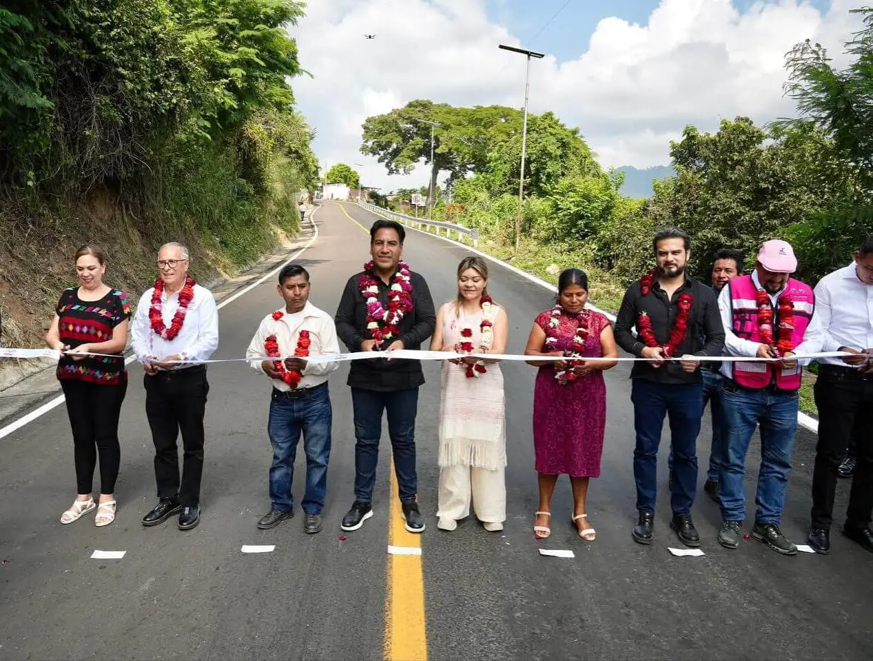 Officials and residents ribbon-cutting ceremony on road