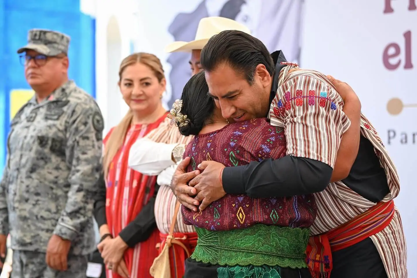 Man embracing woman wearing colorful indigenous clothing