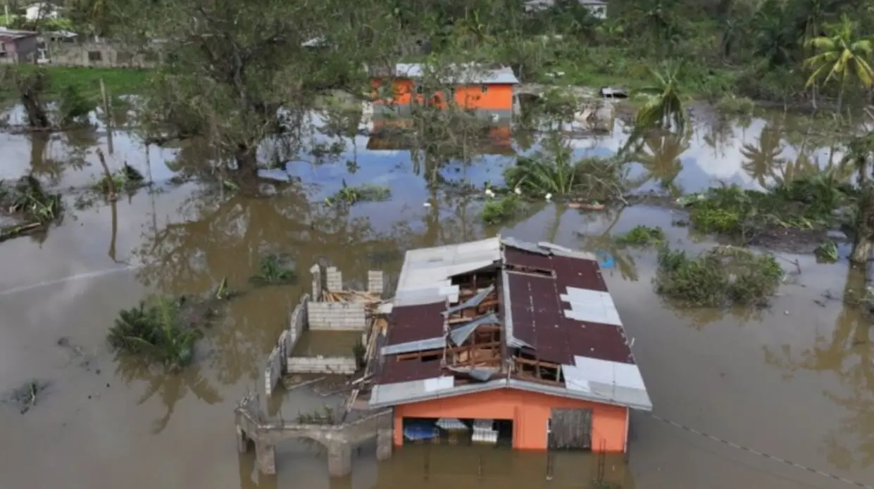 Partially submerged orange house amid floodwater