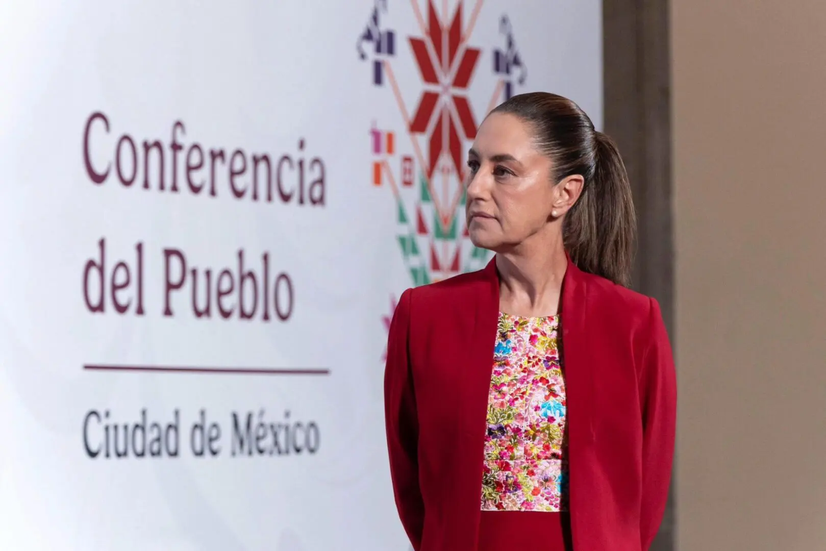 Woman in red blazer at Mexico conference