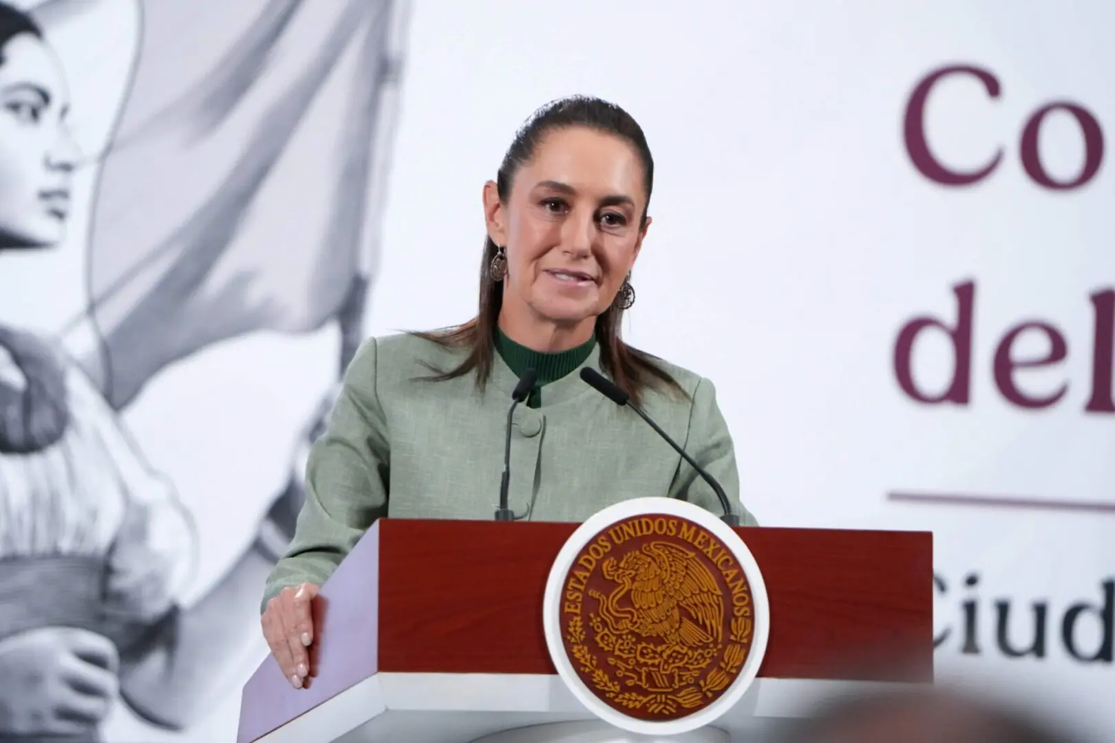Woman speaking at podium with Mexican seal