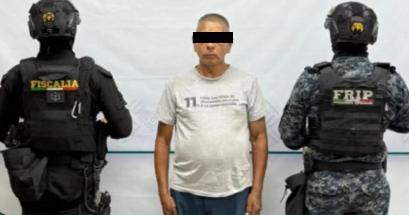 Two officers and a man standing together.