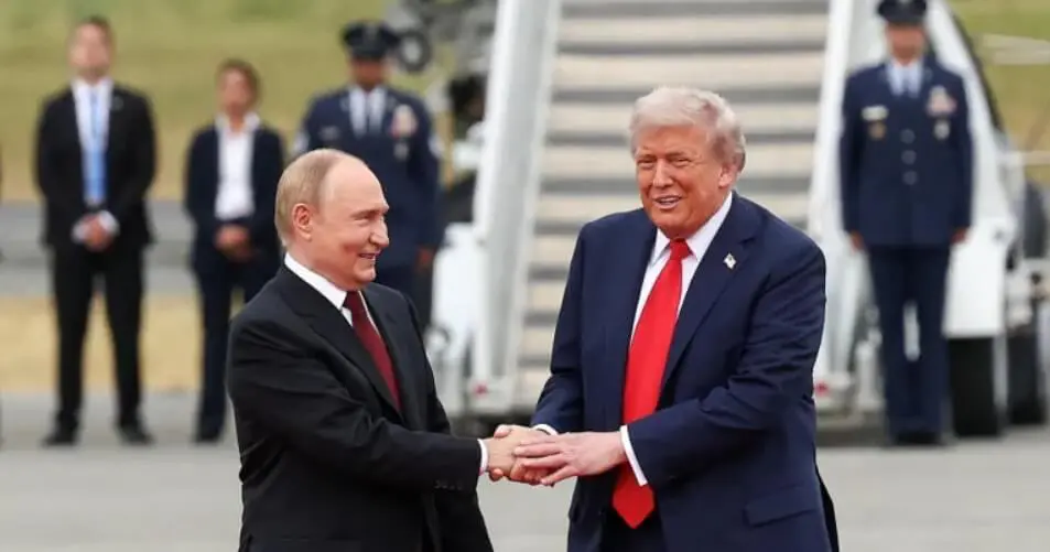 Two men shaking hands by airplane stairs