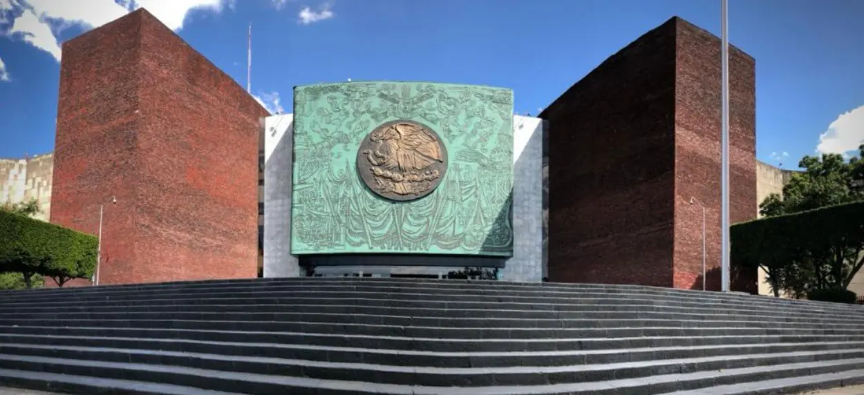 Grand entrance with bronze medallion and steps