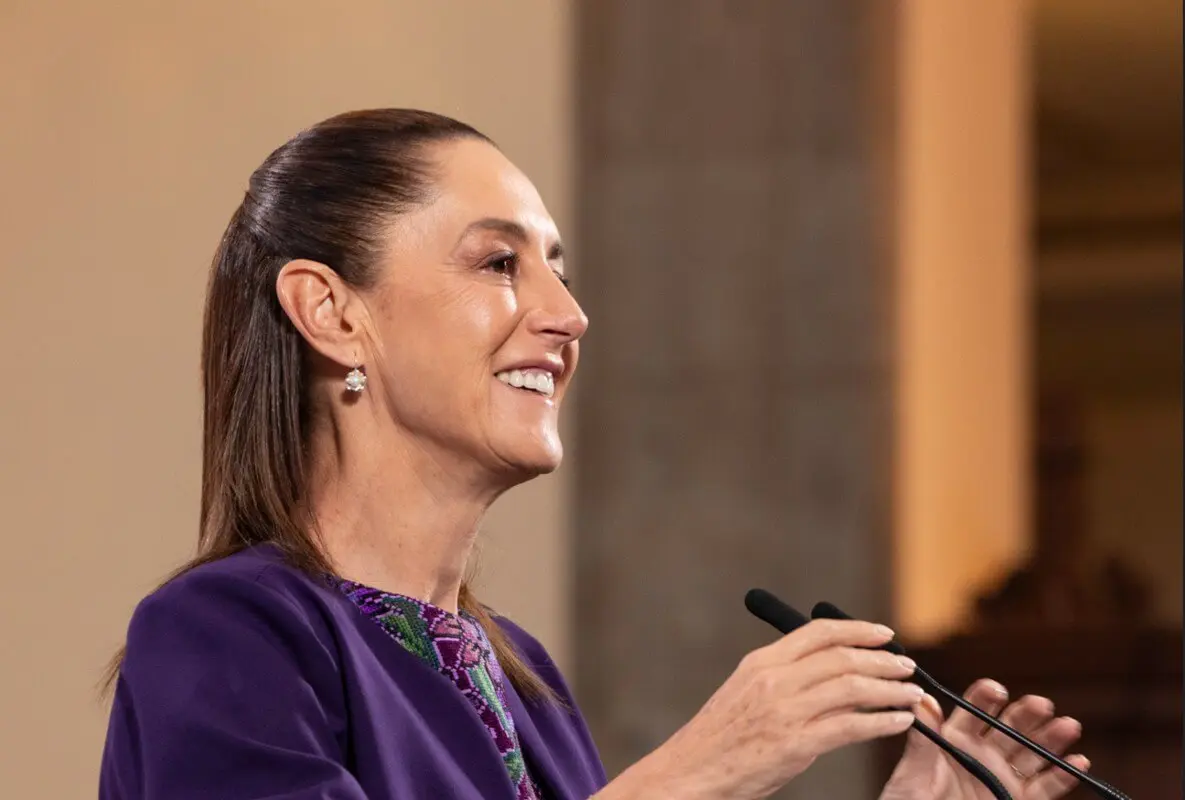 Woman smiling while speaking at podium